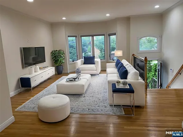 a living room with fireplace furniture and a flat screen tv