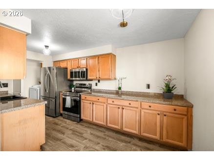 8496 Southwest Mohawk Street Tualatin, OR 97062 - Photo 14 of 39 a kitchen with stainless steel appliances granite countertop a sink a stove and refrigerator