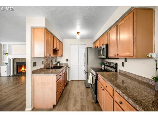 8496 Southwest Mohawk Street Tualatin, OR 97062 - Photo 15 of 39 a kitchen with stainless steel appliances granite countertop a stove a sink and a refrigerator