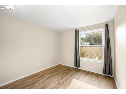 8496 Southwest Mohawk Street Tualatin, OR 97062 - Photo 23 of 39 an empty room with wooden floor and windows