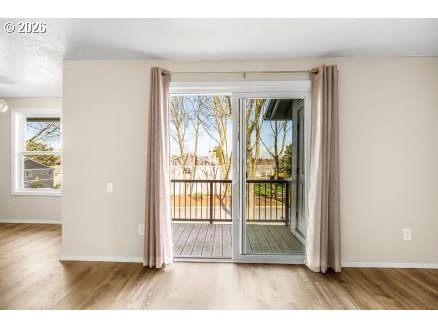 8496 Southwest Mohawk Street Tualatin, OR 97062 - Photo 26 of 39 an empty room with wooden floor and windows