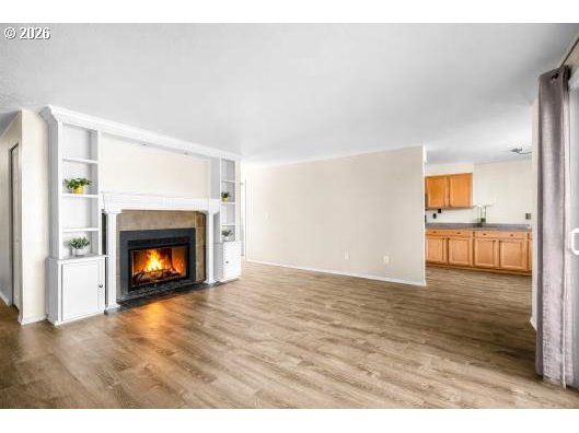 8496 Southwest Mohawk Street Tualatin, OR 97062 - Photo 9 of 39 a view of an empty room with a fireplace and a window
