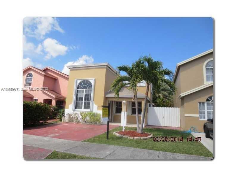 13981 Southwest 160th Terrace, Unit 13981 Miami, FL 33177 - Photo 2 of 7 a front view of a house with garden