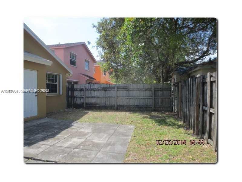 13981 Southwest 160th Terrace, Unit 13981 Miami, FL 33177 - Photo 3 of 7 a view of backyard with wooden fence and large trees