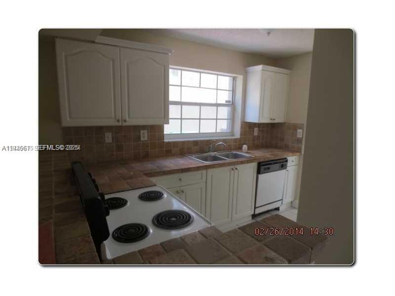 13981 Southwest 160th Terrace, Unit 13981 Miami, FL 33177 - Photo 6 of 7 a kitchen with a sink and cabinets