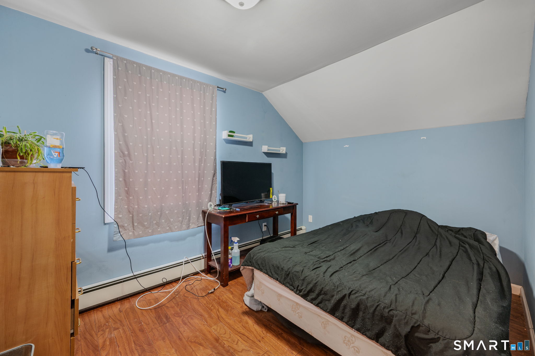 55 Bentley Avenue Norwich, CT 06360 - Photo 13 of 24 a bedroom with a bed and a flat screen tv