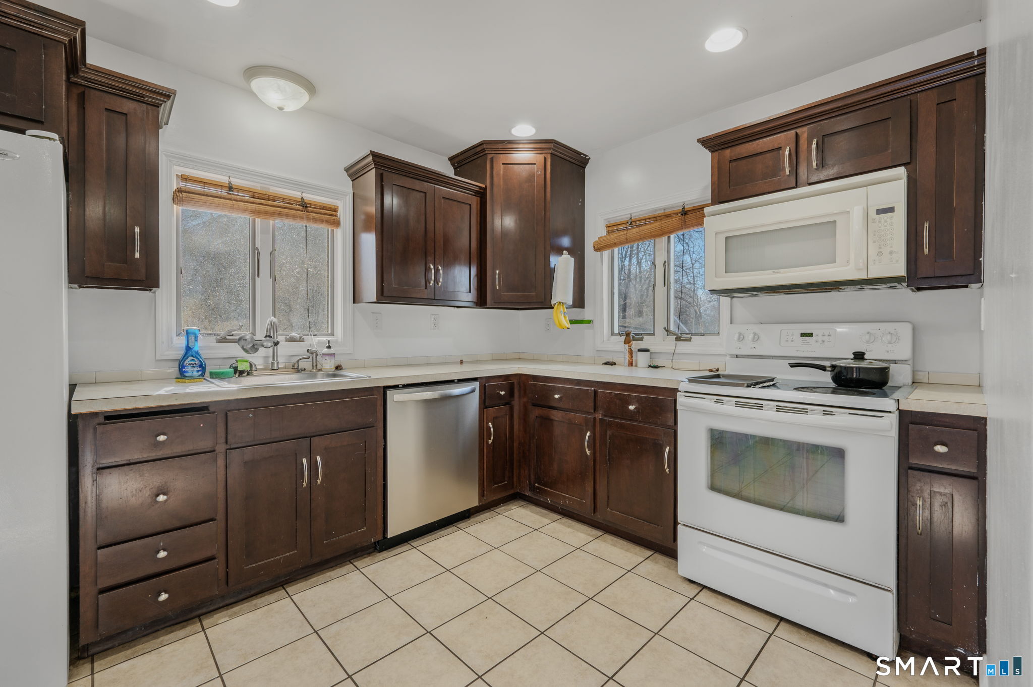 55 Bentley Avenue Norwich, CT 06360 - Photo 8 of 24 a kitchen with a sink stove and microwave