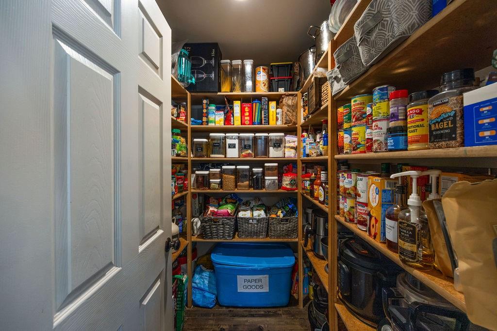 384 Ft Graham Road Waco, TX 76705 - Photo 11 of 36 Walk-in pantry featuring extensive wood shelving, recessed lighting, and a paneled interior door