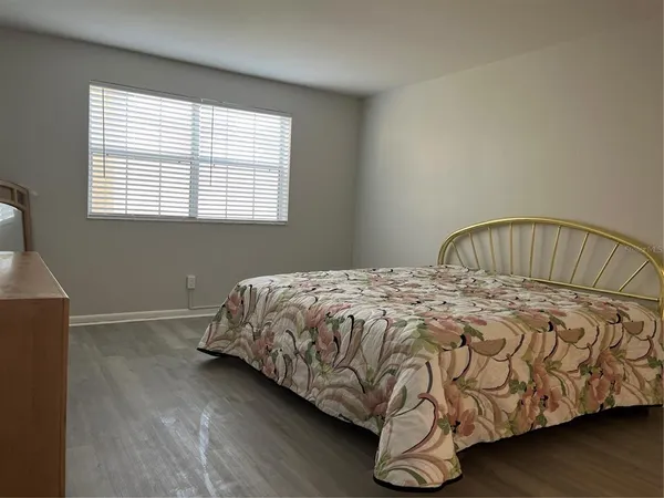 a bedroom with a bed and window