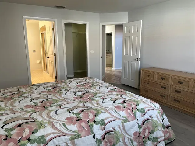 a bedroom with a bed and a dresser