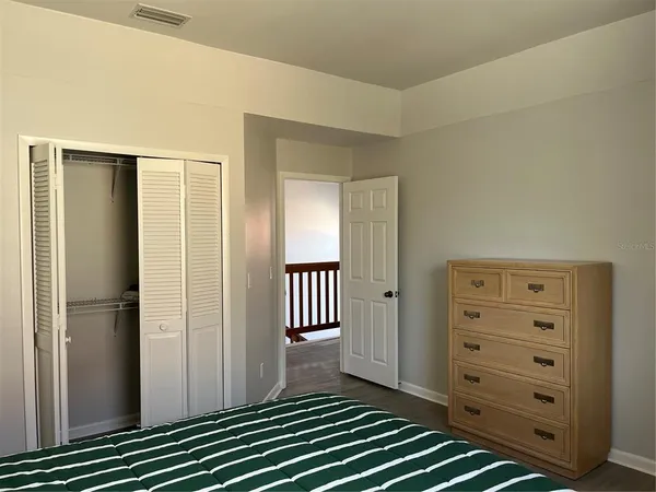 a view of closet with wooden floor