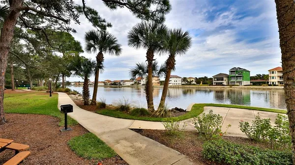 a view of swimming pool with a lake and houses in the back