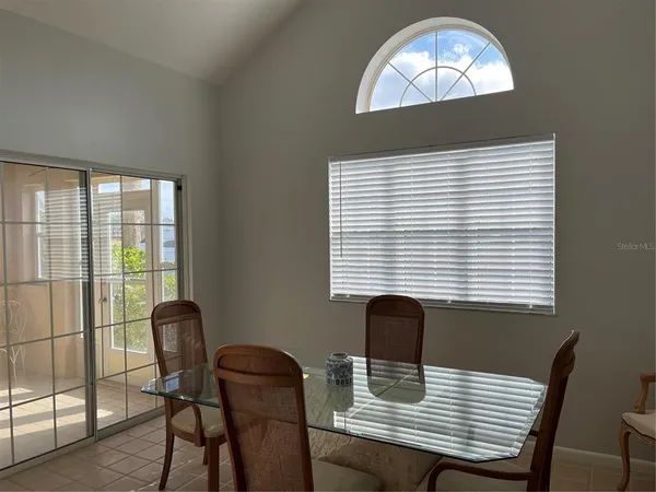 a view of a dining room with furniture and window