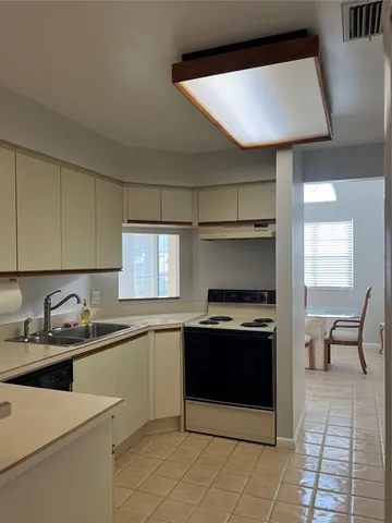 a kitchen with a sink appliances and cabinets