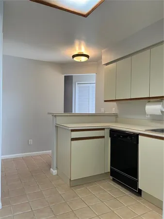 a kitchen with granite countertop white cabinets and a sink