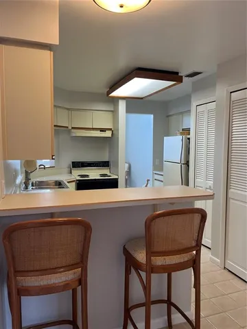 a dining room with table chairs and wooden floor