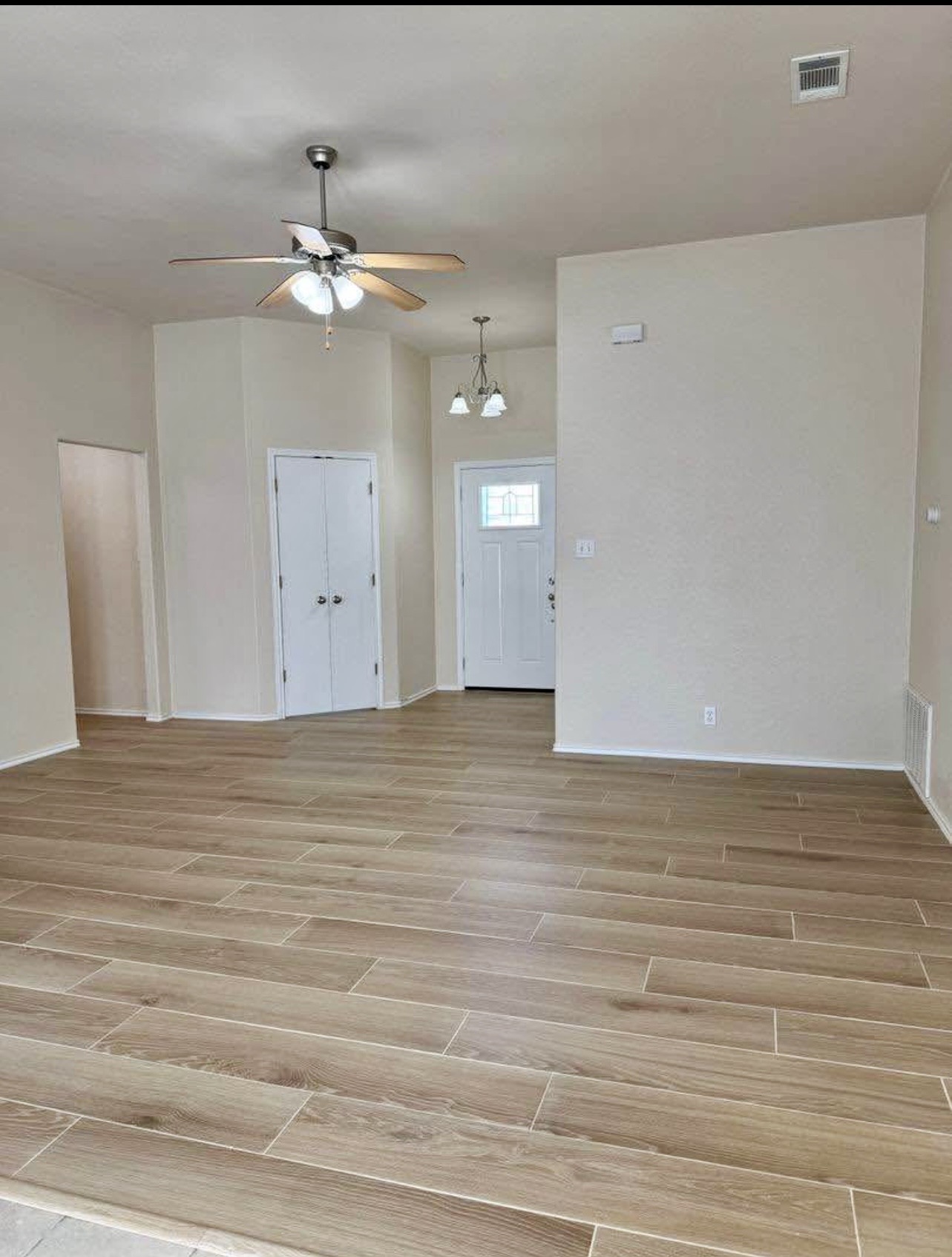400 Blue Shale Drive Jarrell, TX 76537 - Photo 10 of 22 a view of an empty room with wooden floor and a ceiling fan