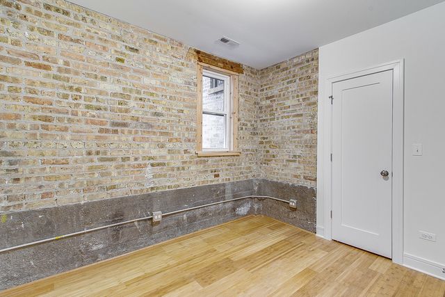 a bathroom with a granite countertop toilet sink mirror and vanity