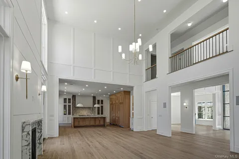 a view of a big room with kitchen and chandelier