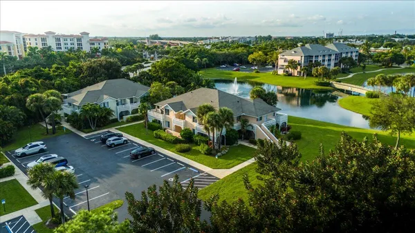 an aerial view of residential houses with outdoor space and river