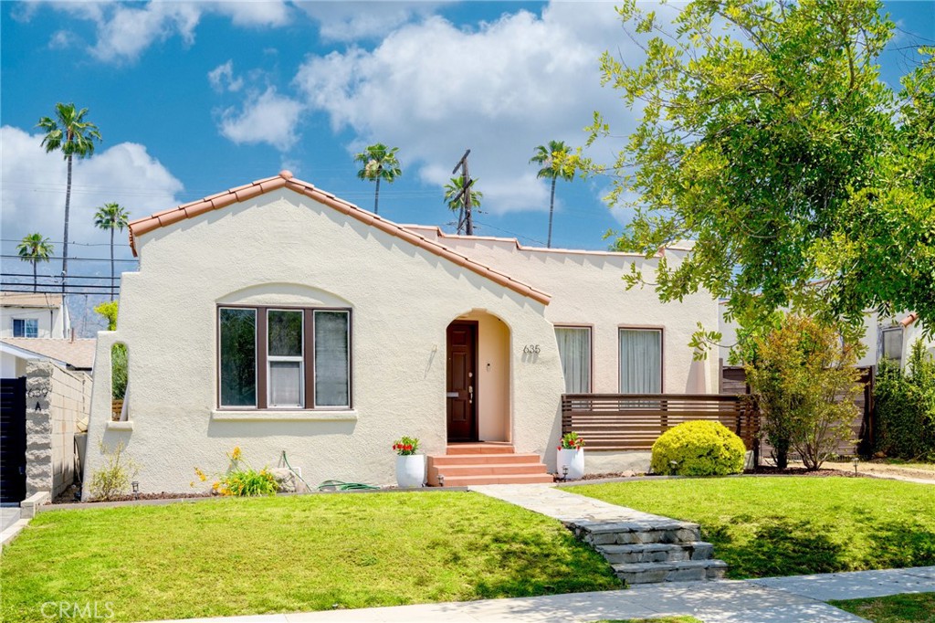 a front view of a house with garden