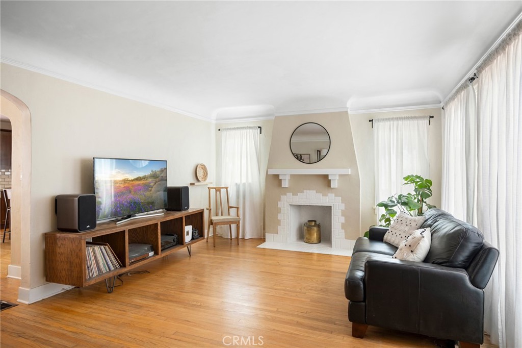 635 Arden Avenue Glendale, CA 91202 - Photo 5 of 36 a living room with furniture a flat screen tv and a fireplace