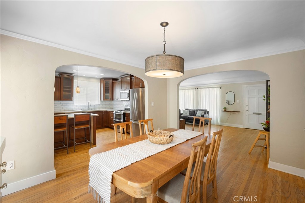 635 Arden Avenue Glendale, CA 91202 - Photo 9 of 36 a dining room with furniture a chandelier and wooden floor