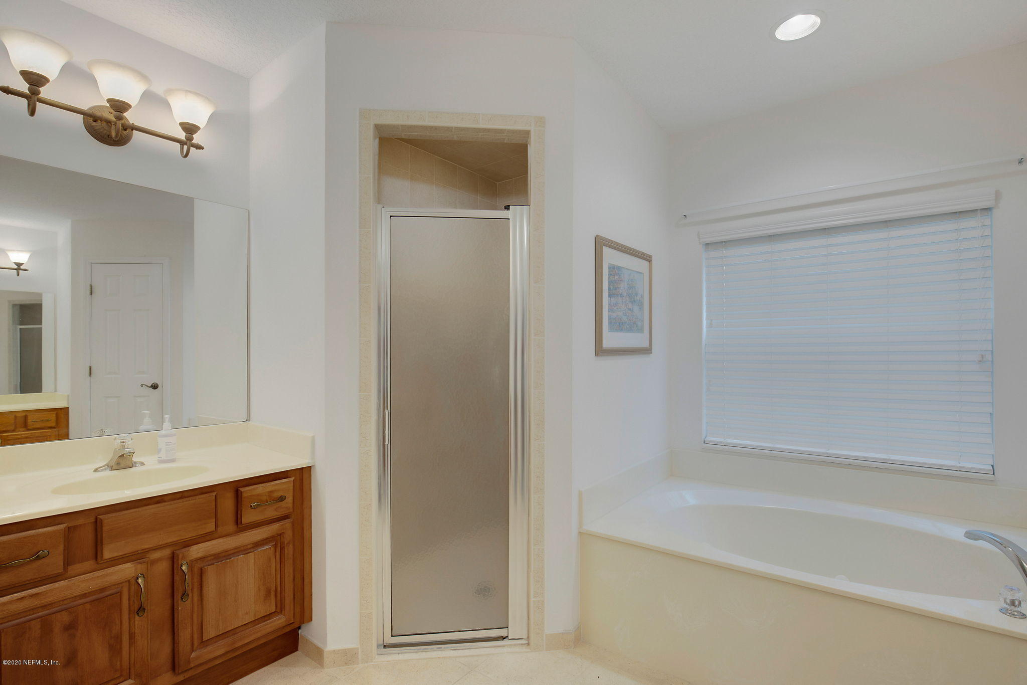 1545 Crichton Road West Jacksonville, FL 32221 - Photo 14 of 30 a bathroom with a bathtub sink vanity and mirror