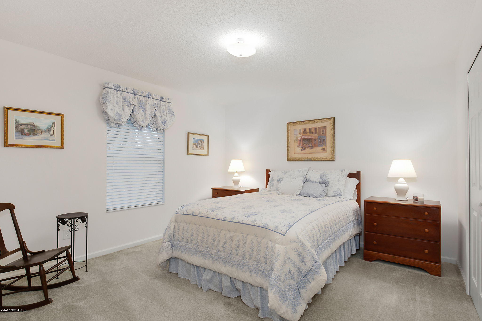 1545 Crichton Road West Jacksonville, FL 32221 - Photo 24 of 30 a bedroom with a bed and a lamp on table
