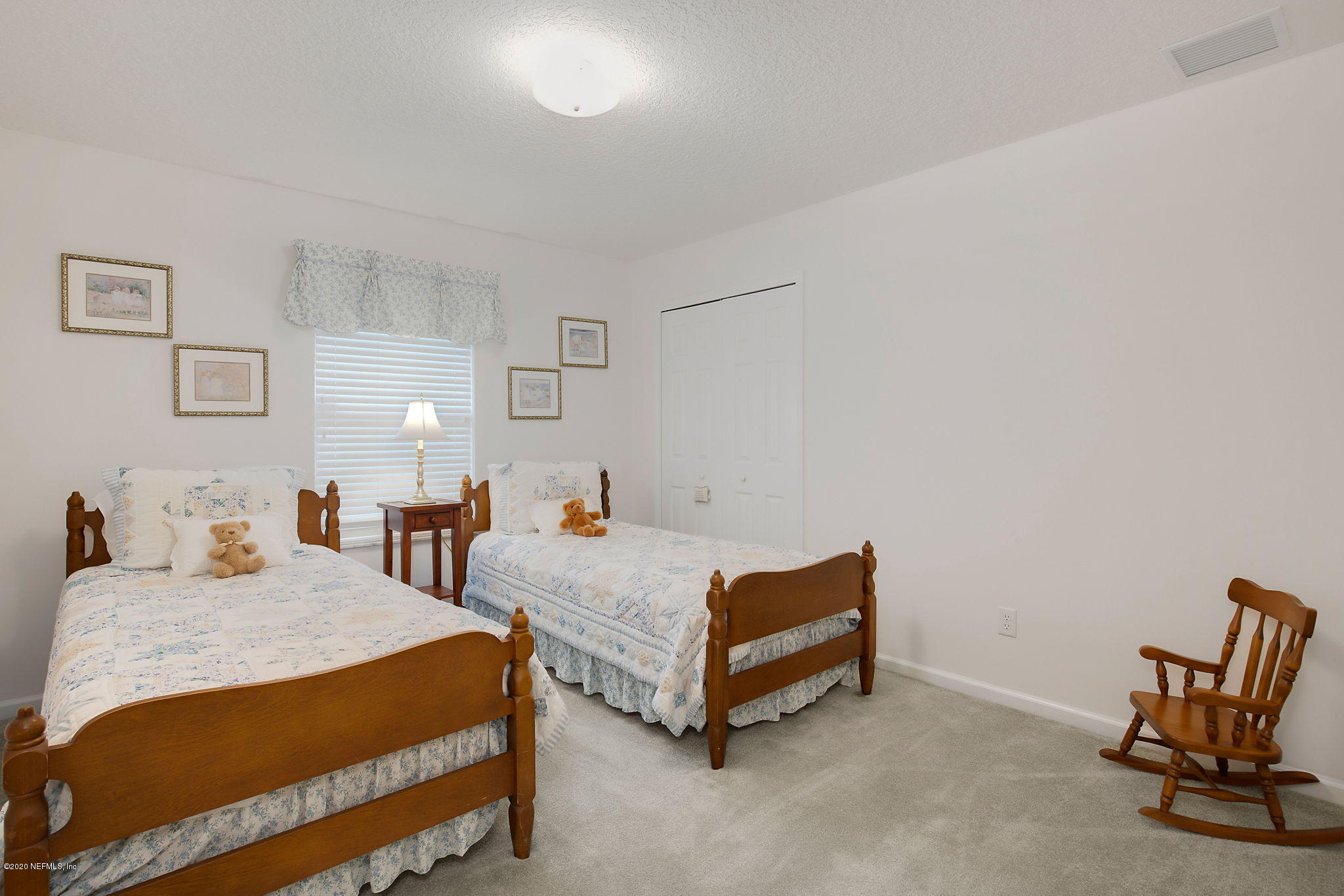 1545 Crichton Road West Jacksonville, FL 32221 - Photo 25 of 30 a bedroom with two beds and a chair