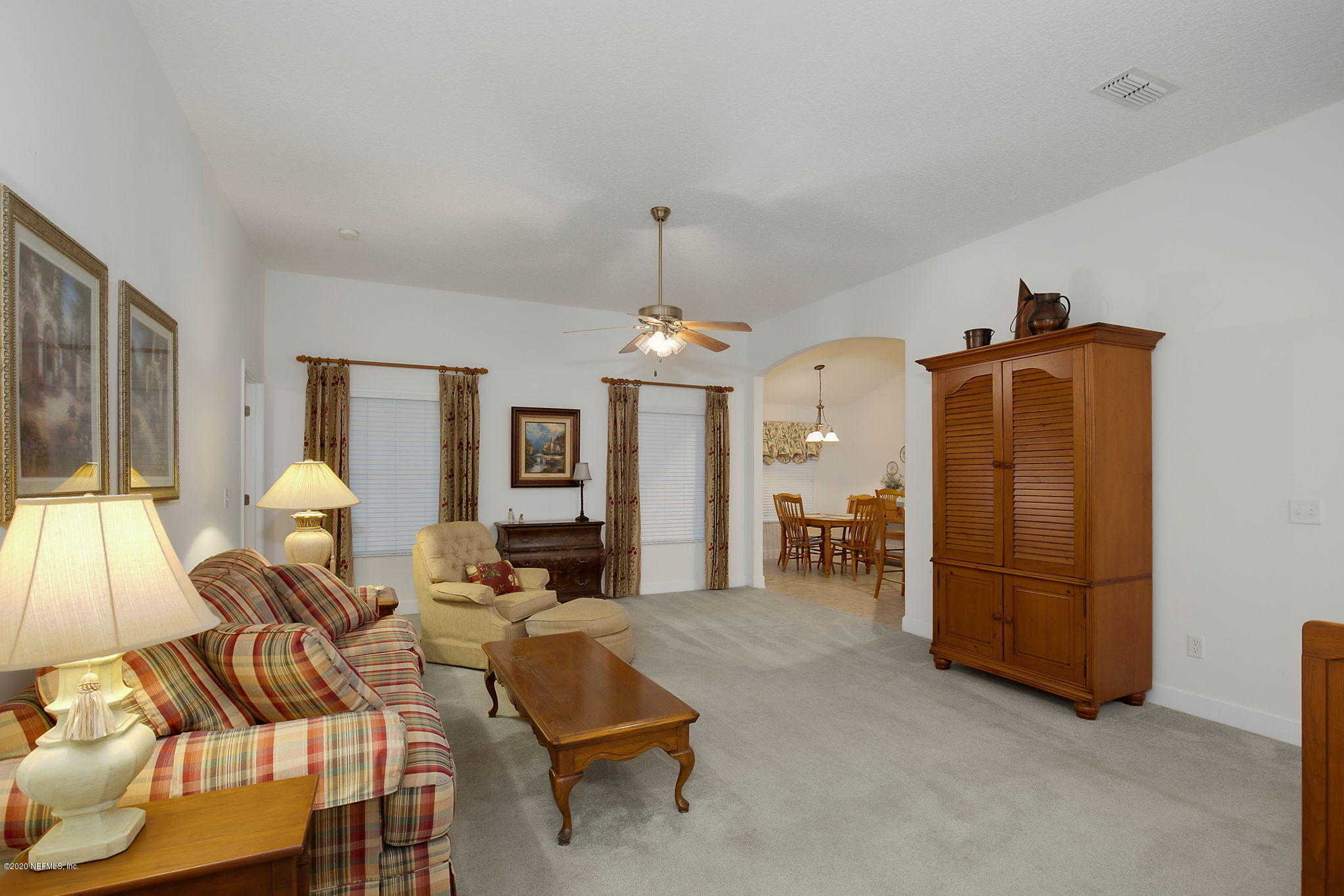1545 Crichton Road West Jacksonville, FL 32221 - Photo 7 of 30 a living room with furniture a dining table and a chandelier