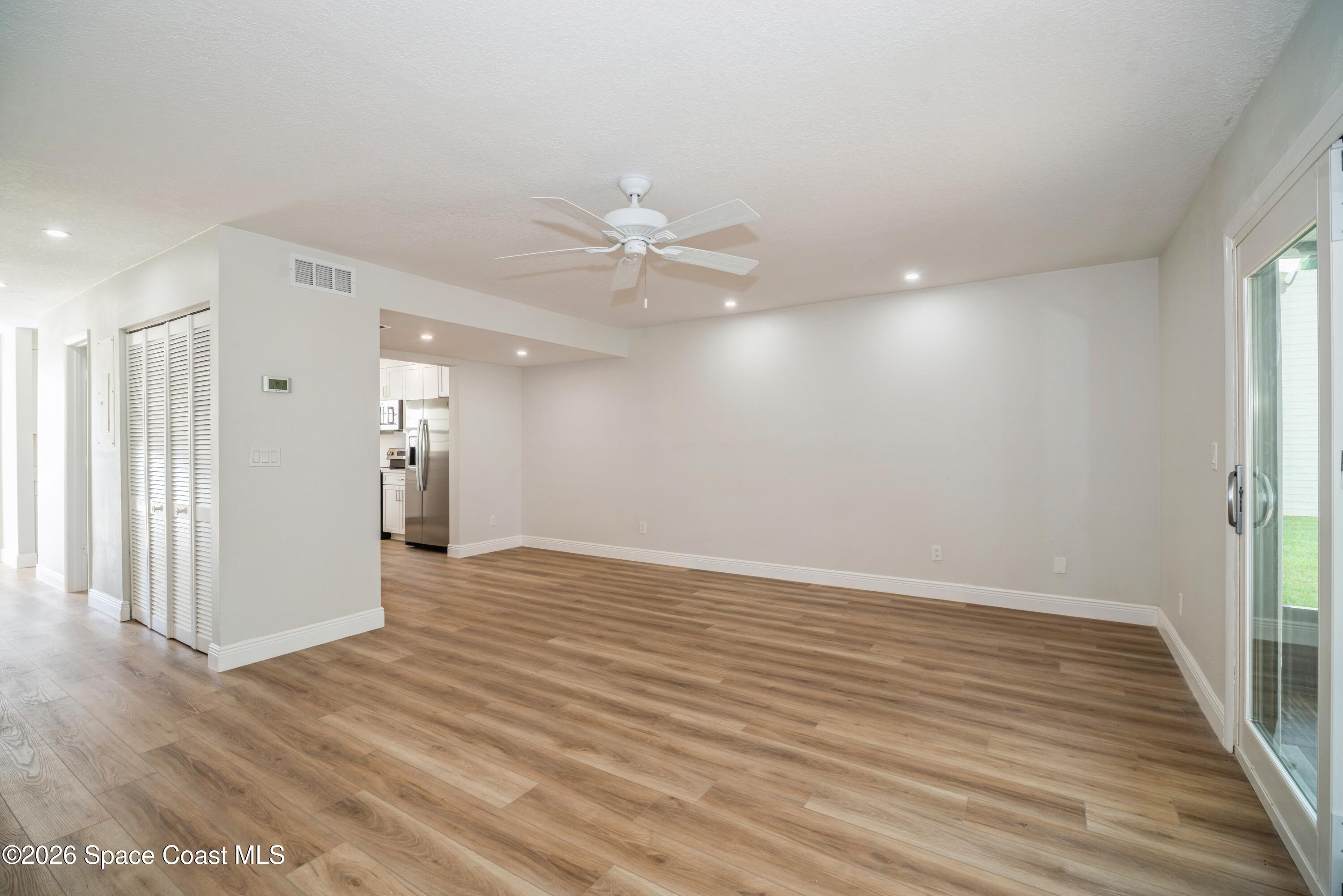 2018 Manor Drive Northeast Palm Bay, FL 32905 - Photo 12 of 29 wooden floor in an empty room with a window