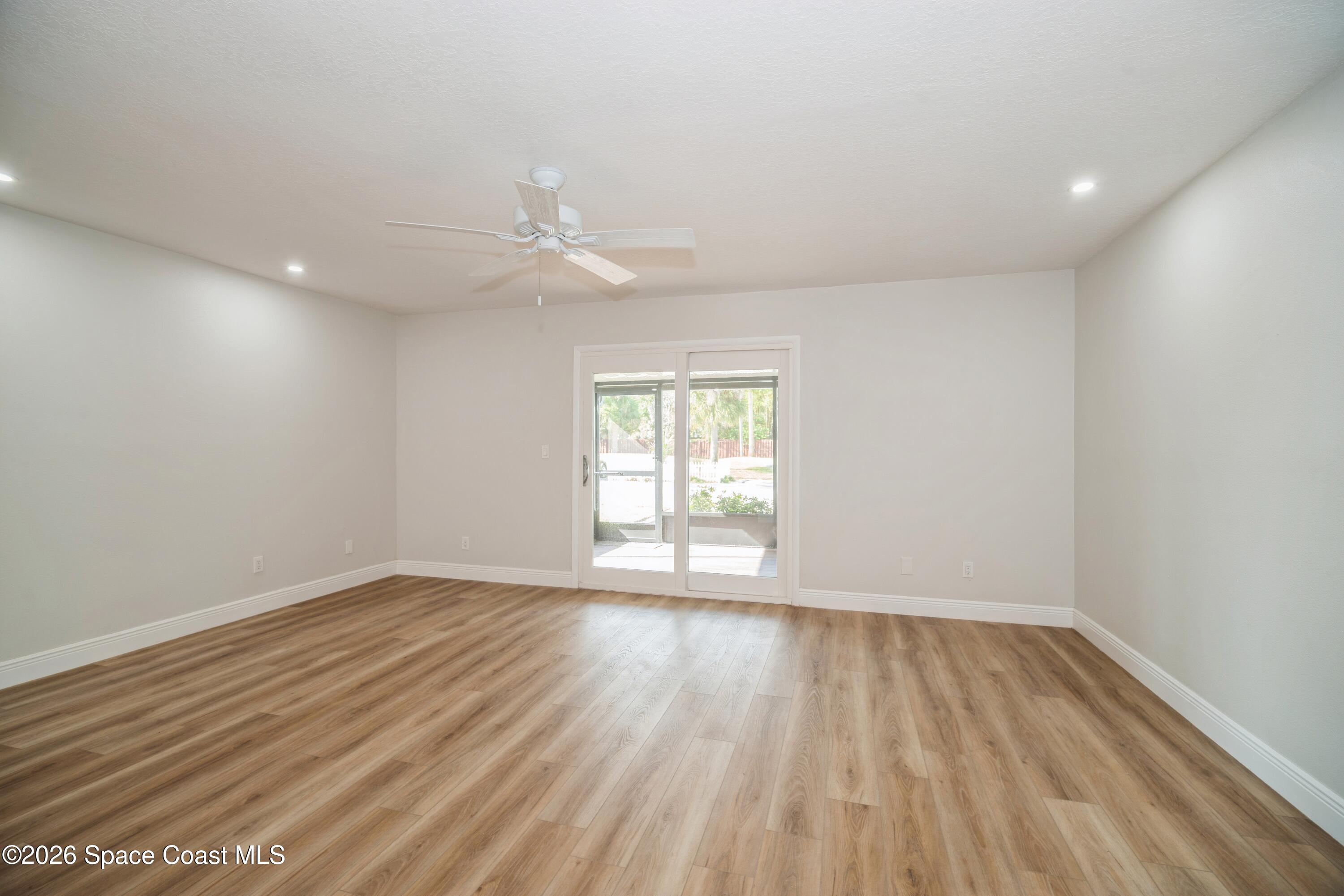 2018 Manor Drive Northeast Palm Bay, FL 32905 - Photo 13 of 29 wooden floor in an empty room with a window