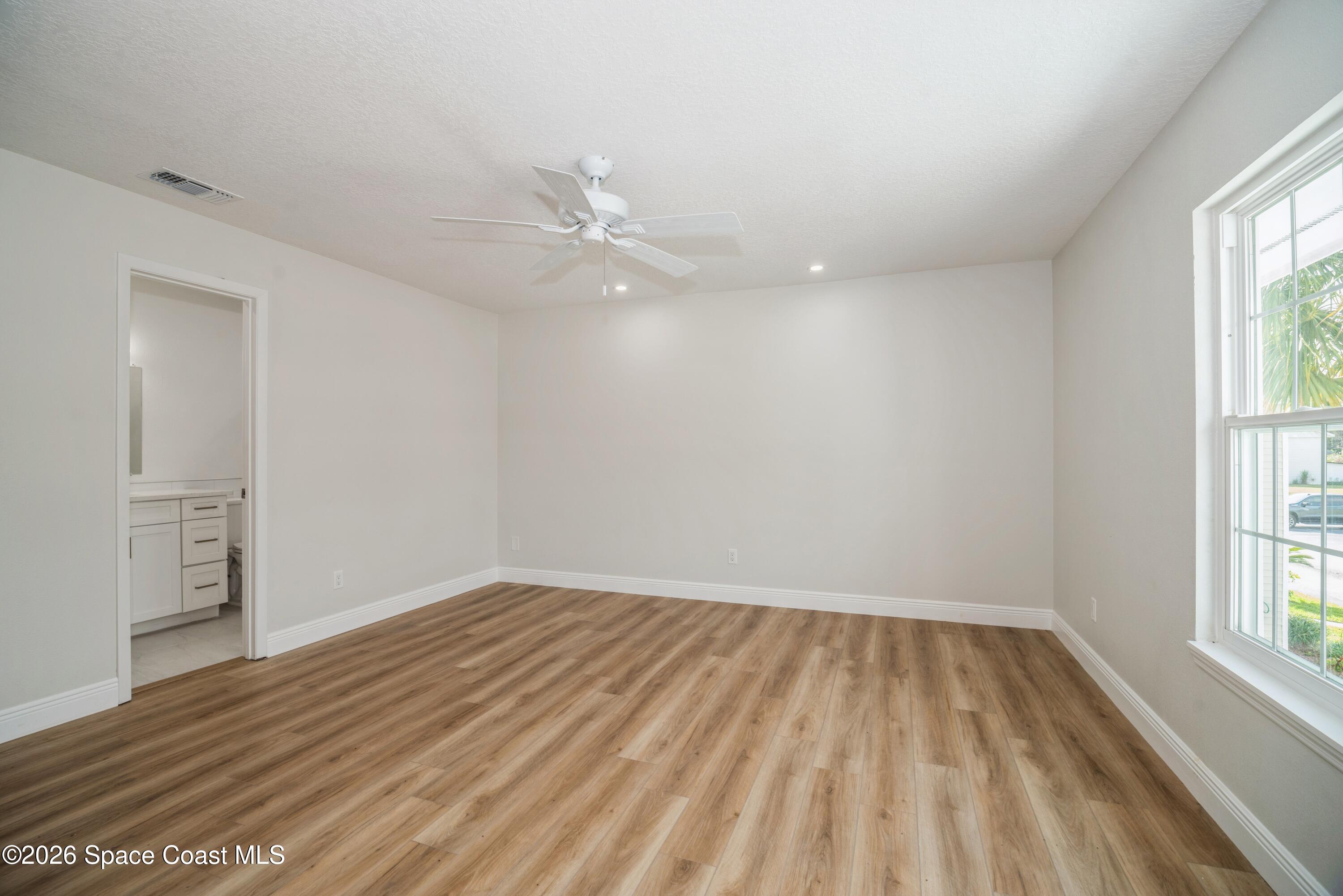 2018 Manor Drive Northeast Palm Bay, FL 32905 - Photo 19 of 29 wooden floor in an empty room with a window