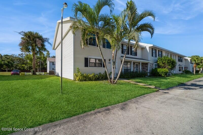 2018 Manor Drive Northeast Palm Bay, FL 32905 - Photo 2 of 29 a front view of house with yard and green space