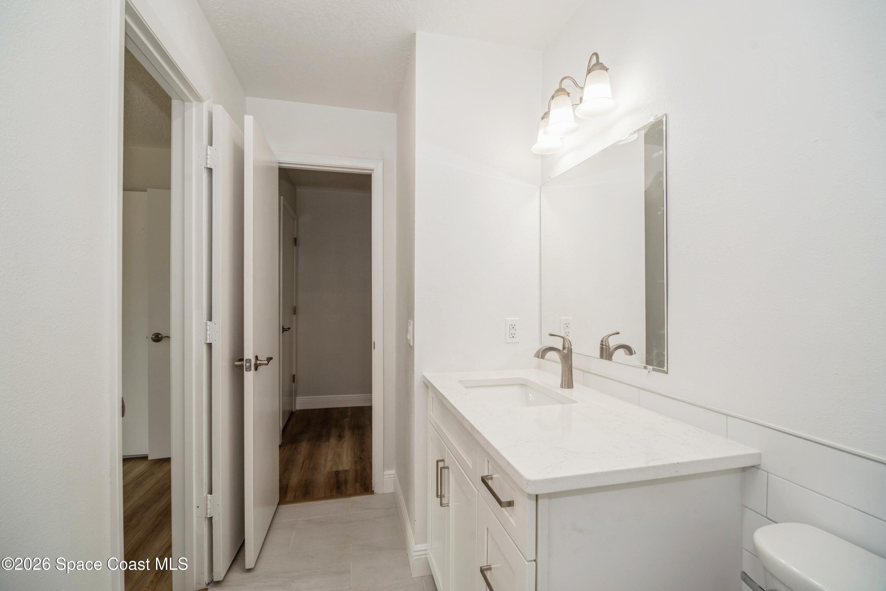 2018 Manor Drive Northeast Palm Bay, FL 32905 - Photo 21 of 29 a bathroom with a sink toilet and shower