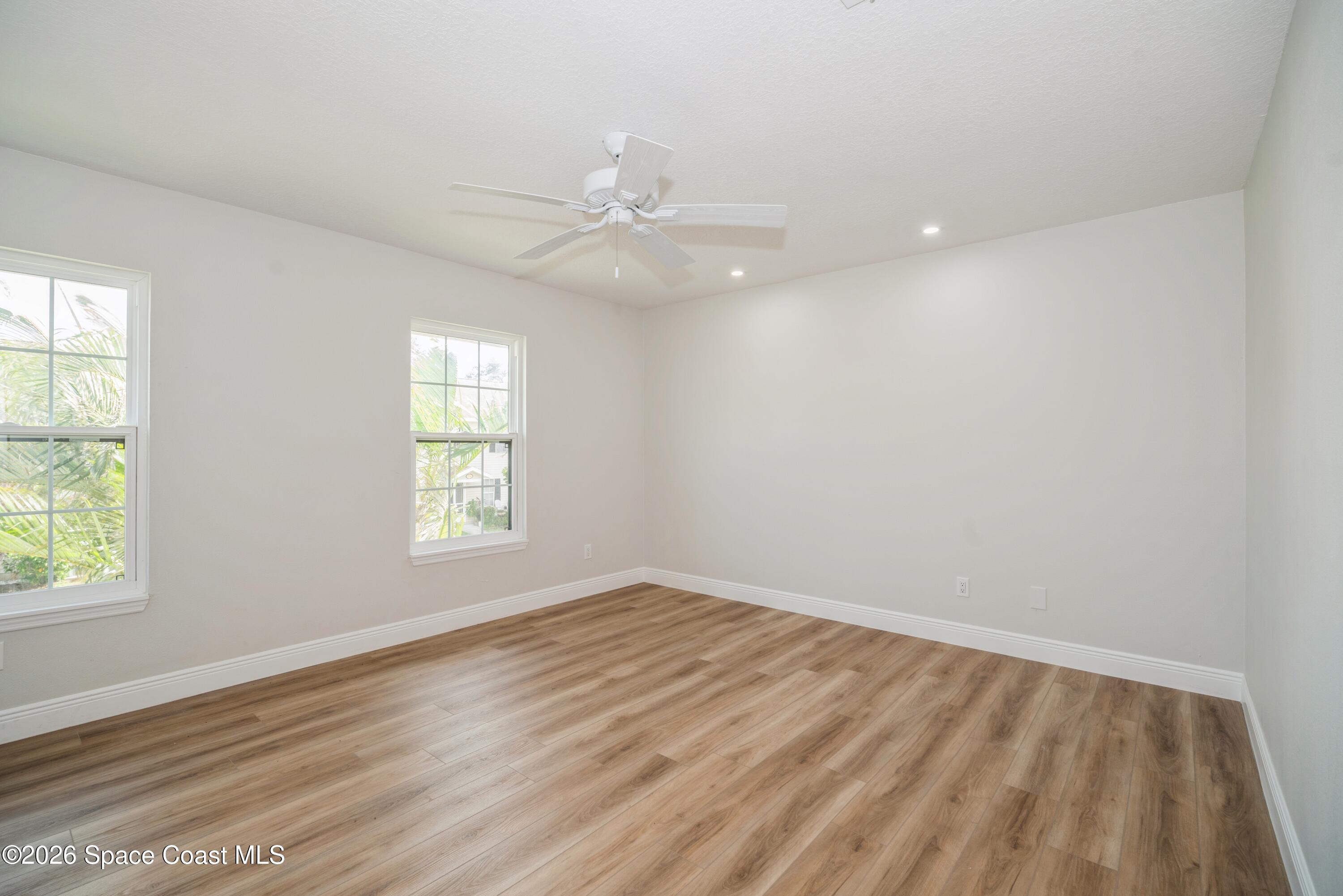 2018 Manor Drive Northeast Palm Bay, FL 32905 - Photo 22 of 29 wooden floor in an empty room with a window