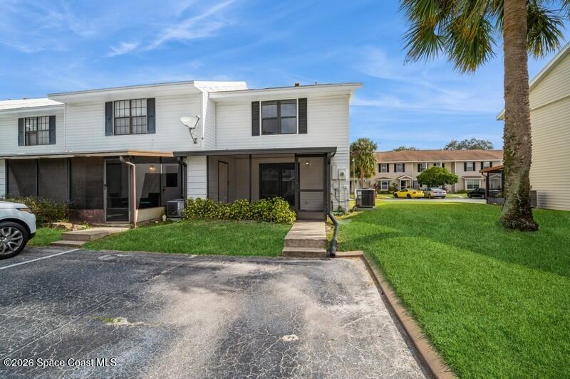 2018 Manor Drive Northeast Palm Bay, FL 32905 - Photo 24 of 29 a front view of a house with a yard and garage