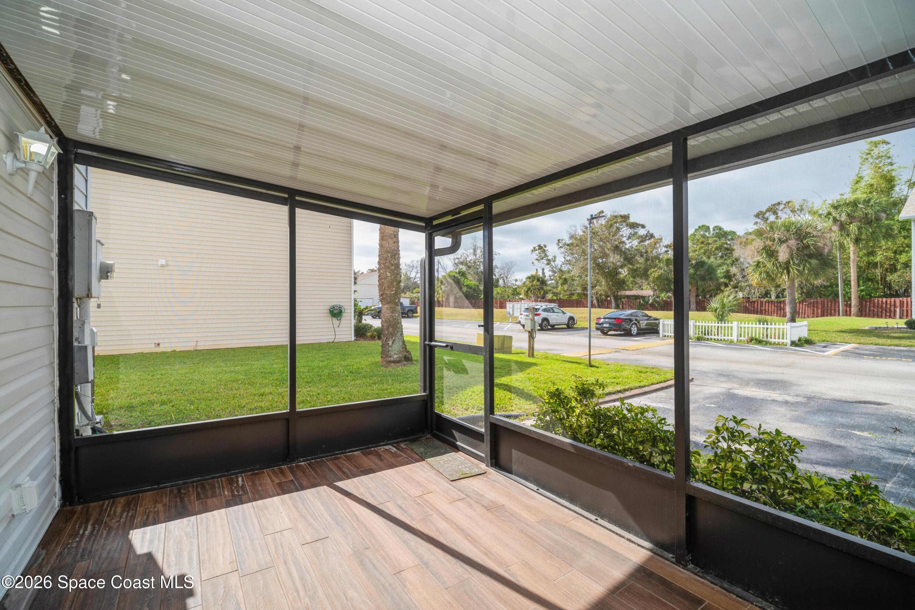 2018 Manor Drive Northeast Palm Bay, FL 32905 - Photo 26 of 29 a view of a porch with a floor to ceiling window next to a yard