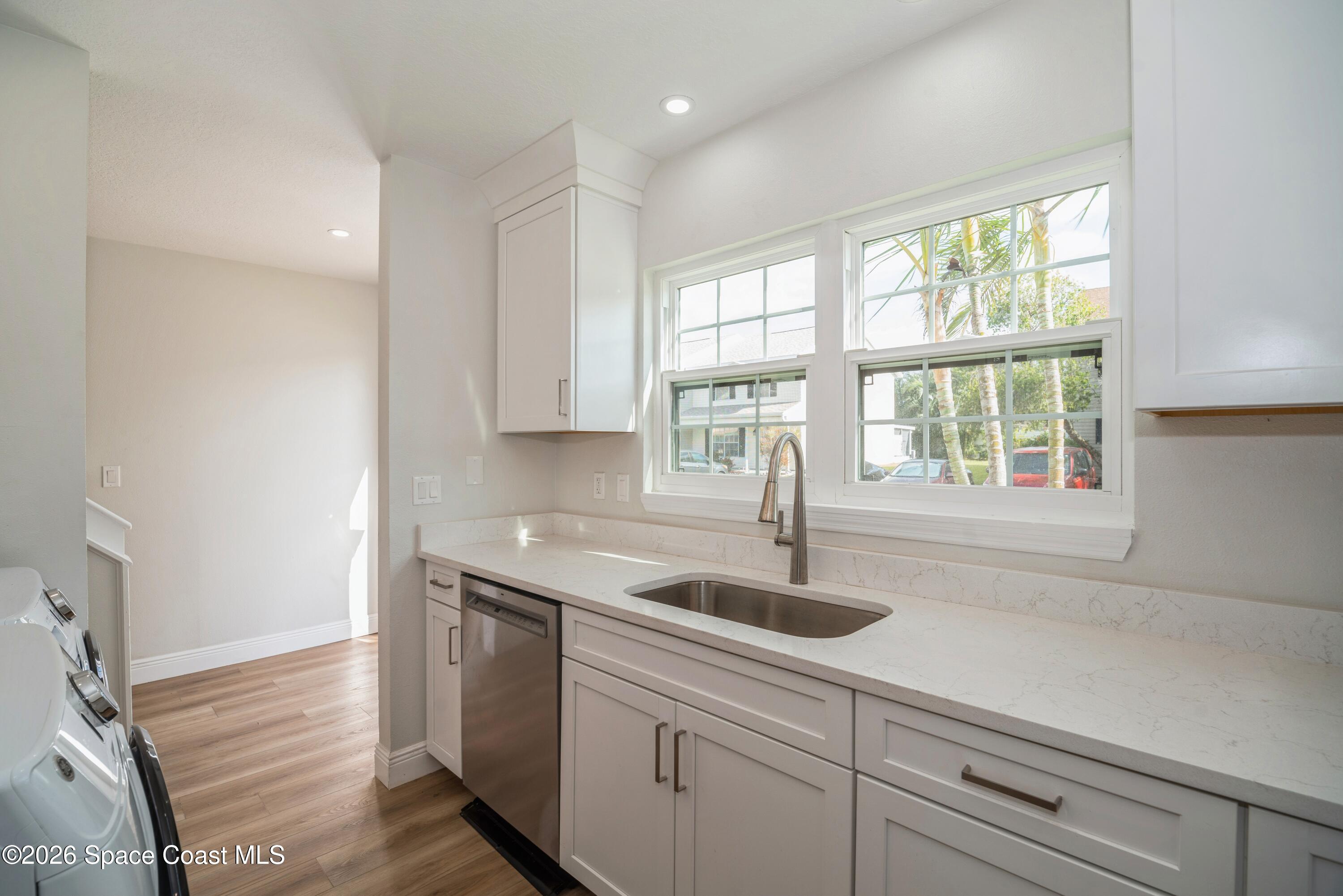 2018 Manor Drive Northeast Palm Bay, FL 32905 - Photo 4 of 29 a kitchen with a sink and cabinets