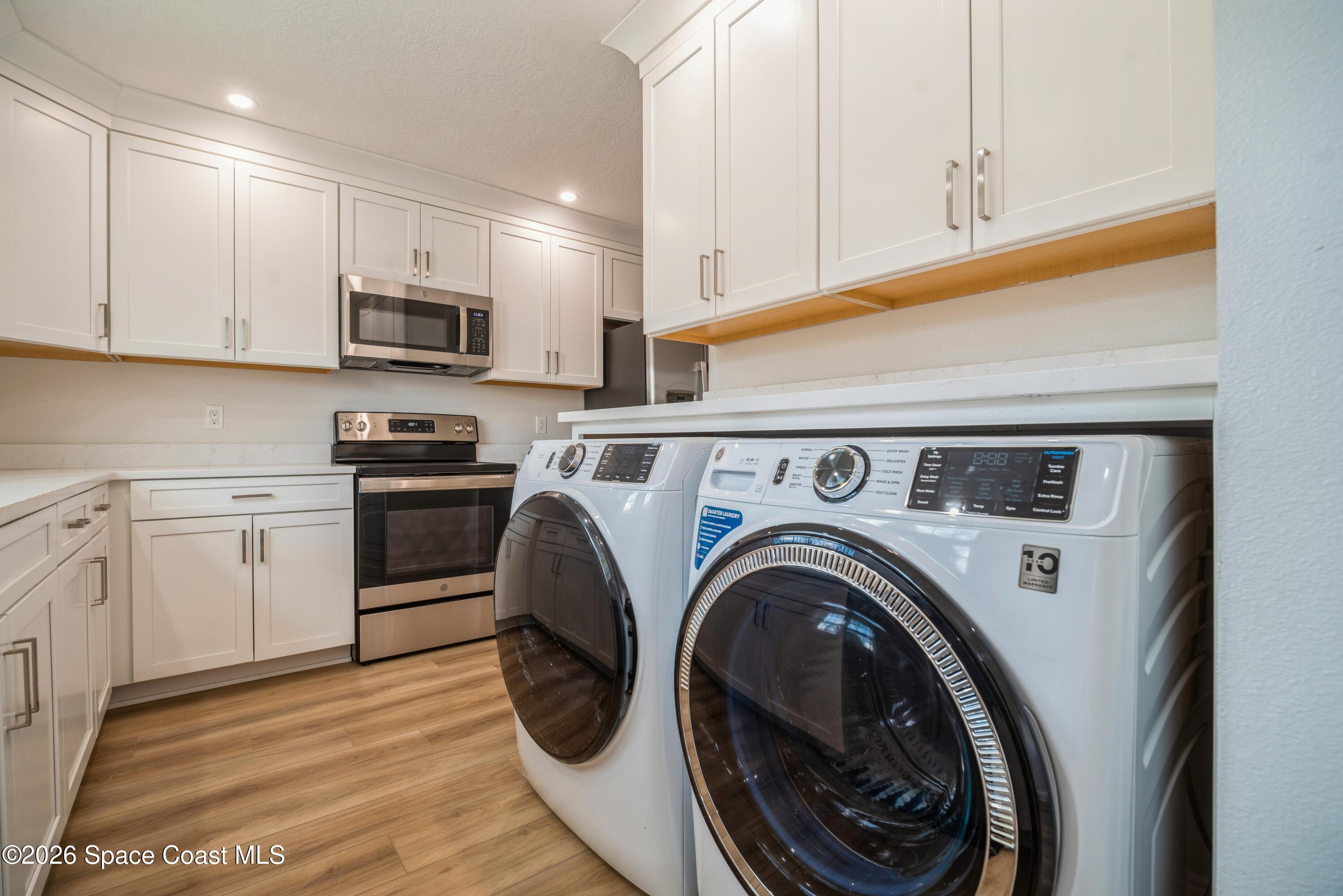 2018 Manor Drive Northeast Palm Bay, FL 32905 - Photo 8 of 29 a utility room with sink dryer and washer