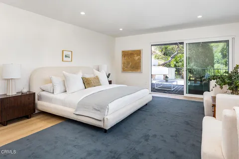 a bed room with a bed and a large window