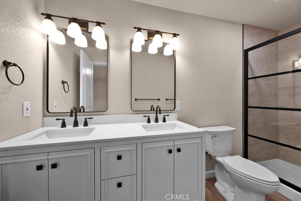 8395 Amapoa Atascadero, CA 93422 - Photo 13 of 22 a bathroom with a double vanity sink mirror and toilet