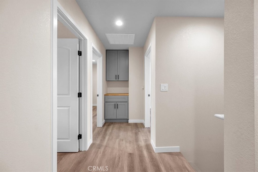 8395 Amapoa Atascadero, CA 93422 - Photo 15 of 22 a view of a hallway with wooden floor and a bathroom