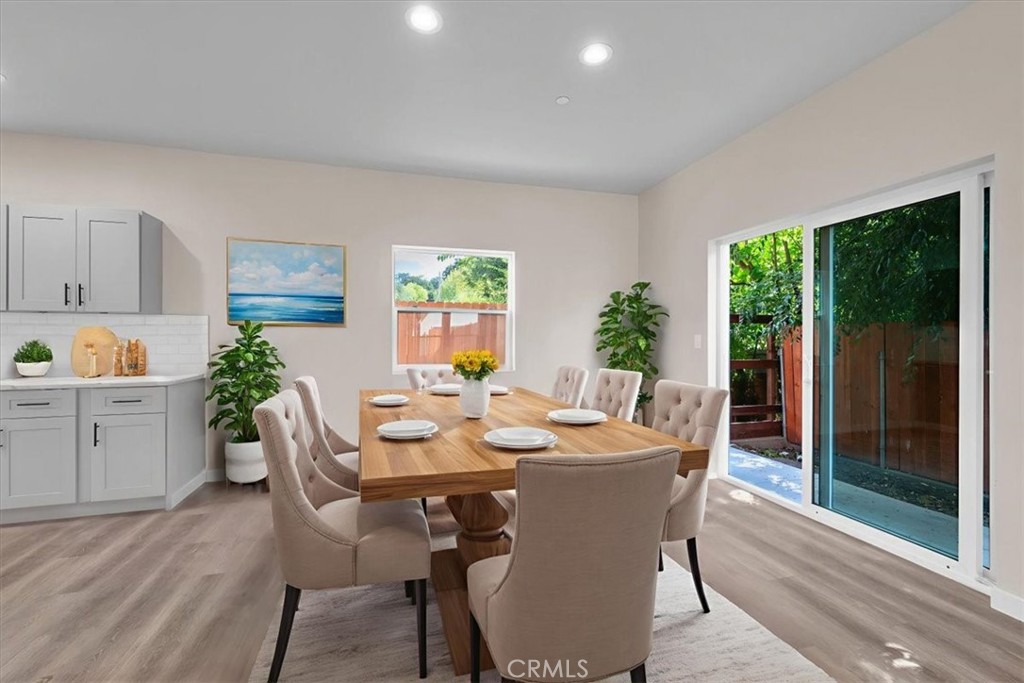 8395 Amapoa Atascadero, CA 93422 - Photo 5 of 22 a dining room with furniture potted plants and wooden floor