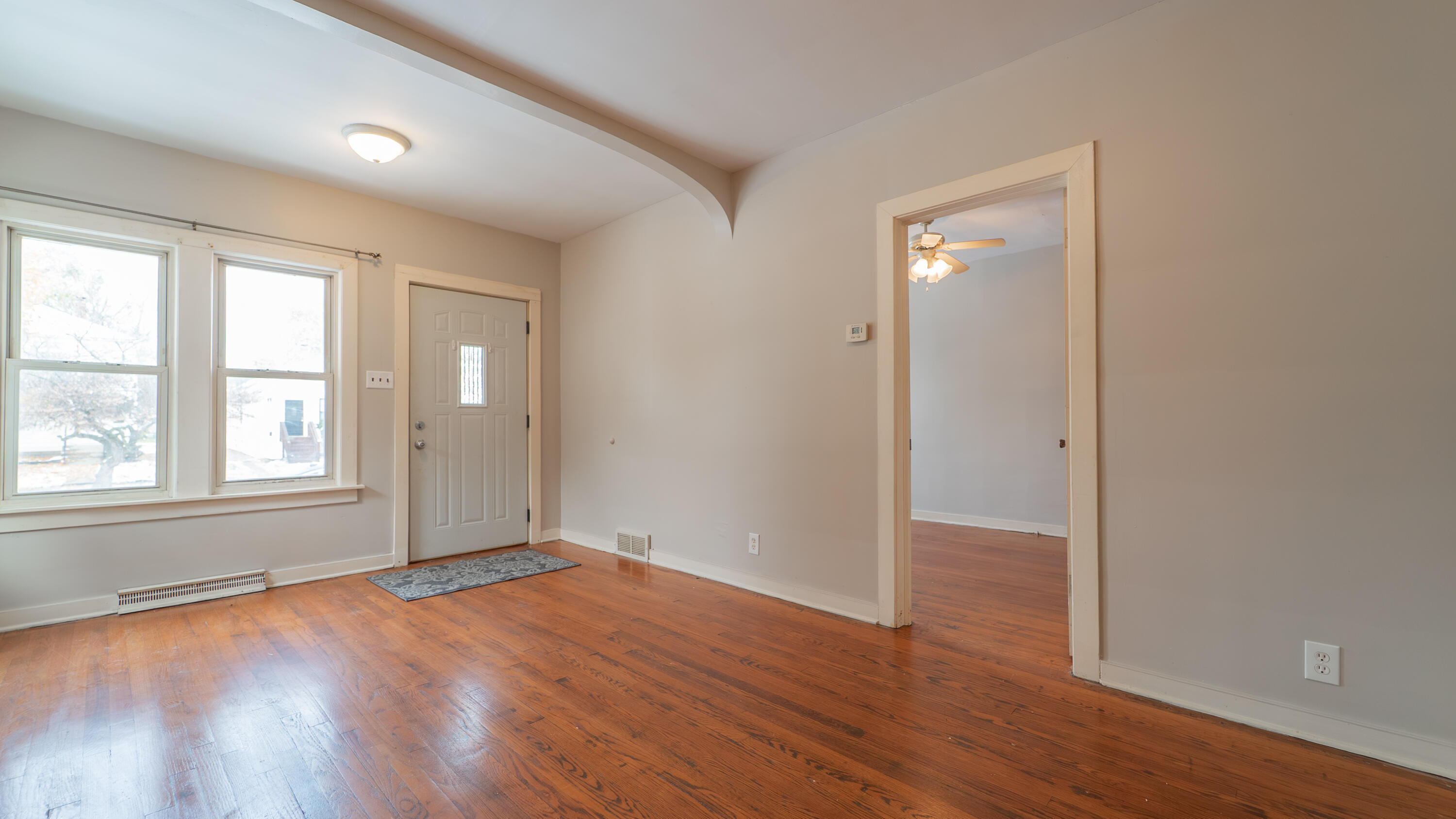 718 Cherry Street Hammond, IN 46324 - Photo 2 of 17 an empty room with wooden floor and windows