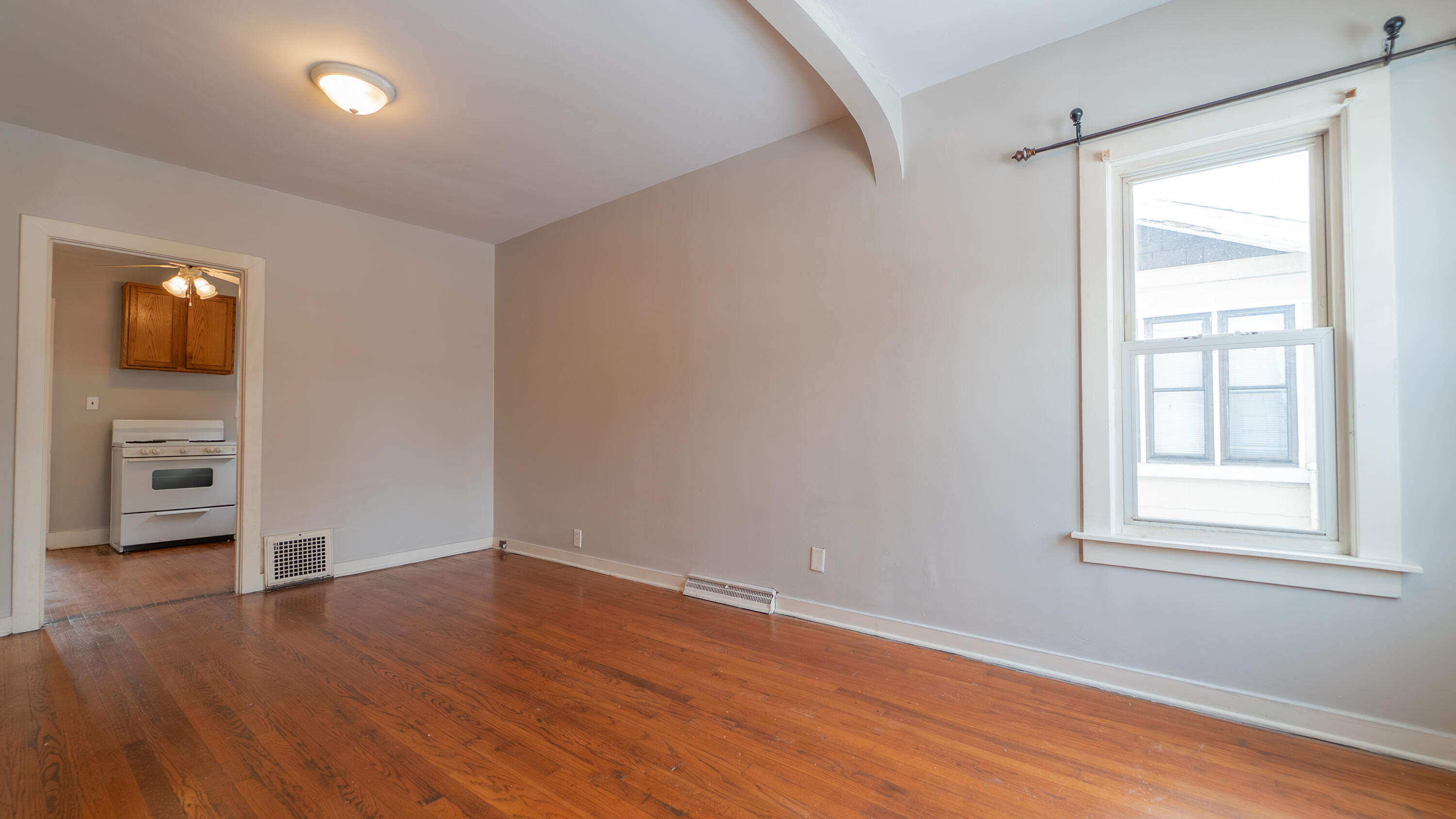 718 Cherry Street Hammond, IN 46324 - Photo 3 of 17 wooden floor in an empty room with a window