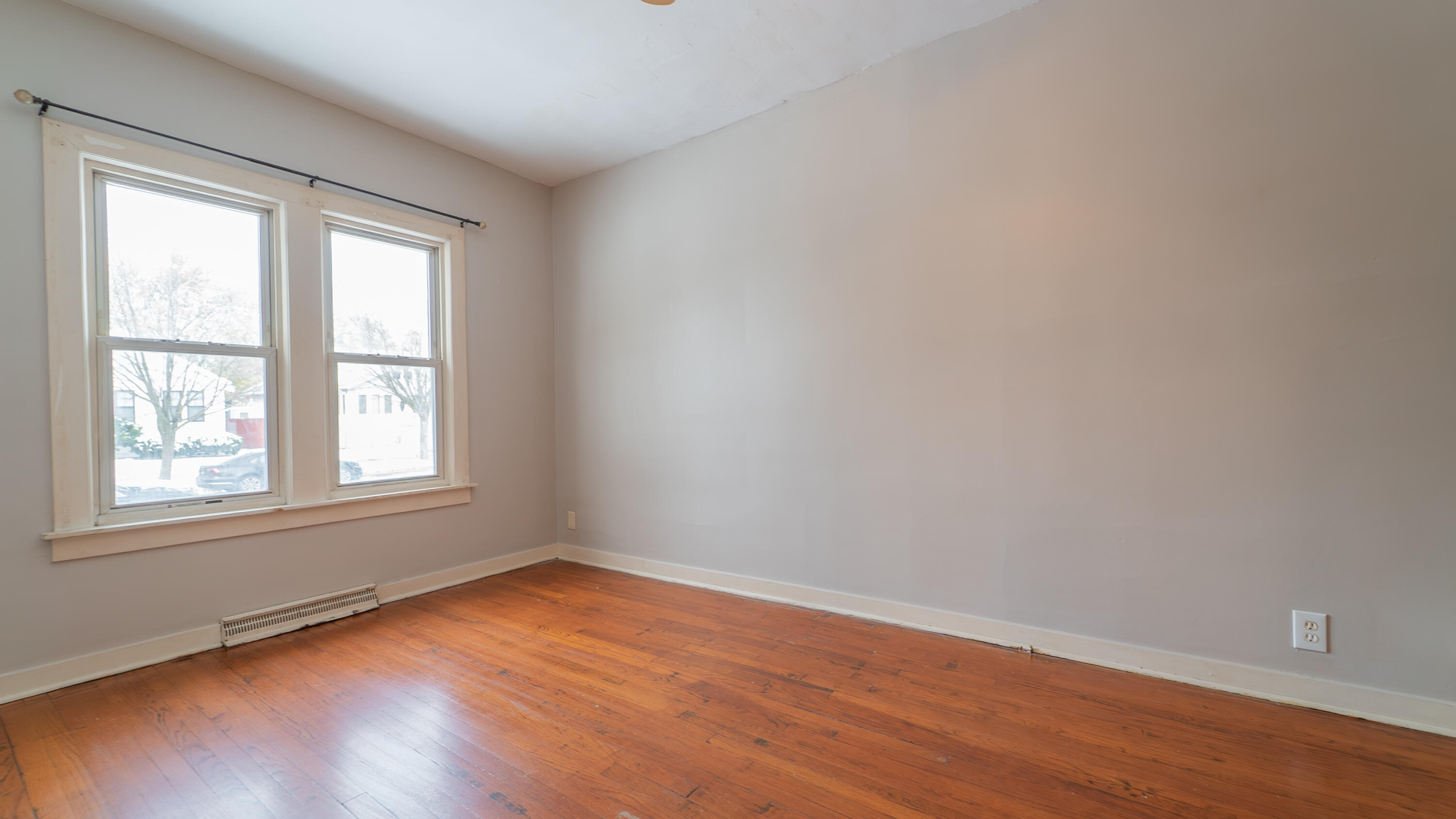 718 Cherry Street Hammond, IN 46324 - Photo 4 of 17 an empty room with wooden floor and windows