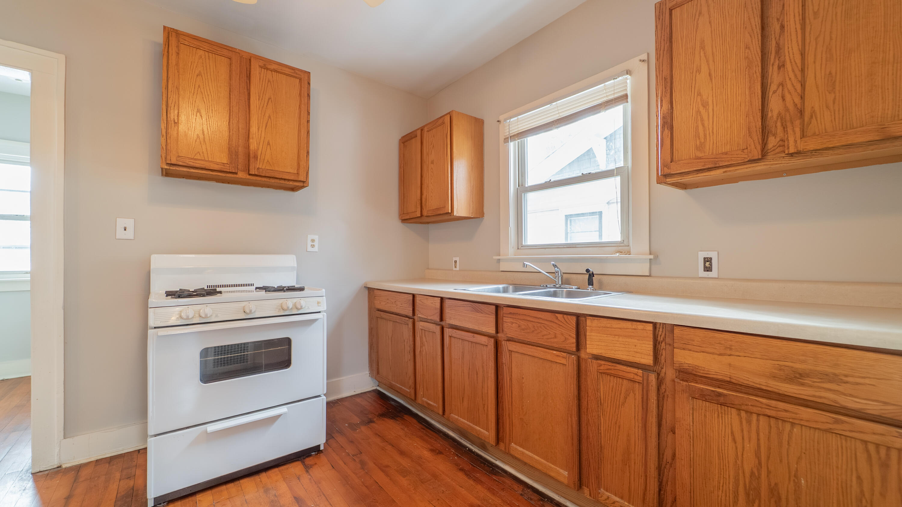 718 Cherry Street Hammond, IN 46324 - Photo 6 of 17 a kitchen with stainless steel appliances granite countertop a stove a sink and a microwave