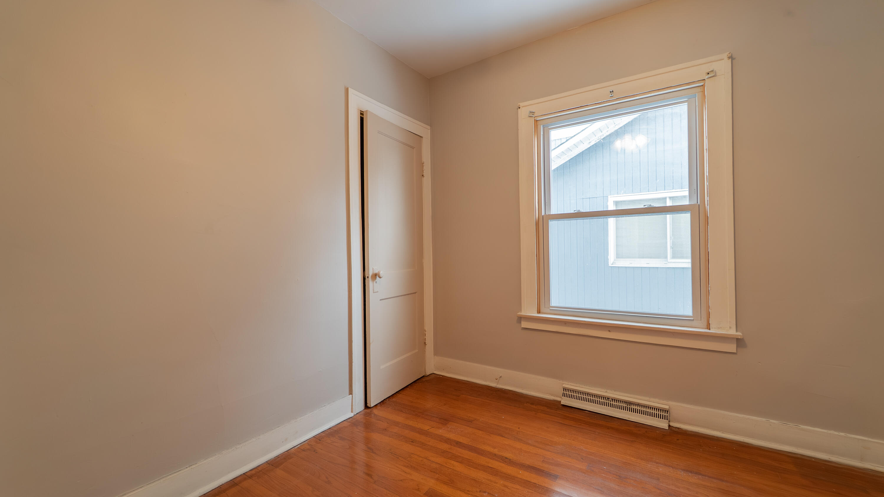 718 Cherry Street Hammond, IN 46324 - Photo 9 of 17 a view of an empty room with wooden floor and a window